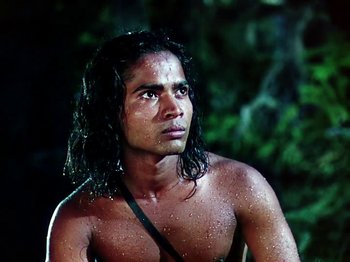 Movie still from “The Jungle Book” (1942), directed by Zoltan Korda – A man with long hair is standing in the rain; Close Up shot, Low angle