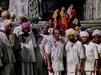 Movie still from “The Jungle Book” (1942), directed by Zoltan Korda – A large group of men standing next to each other wearing turbans; Wide shot, High angle