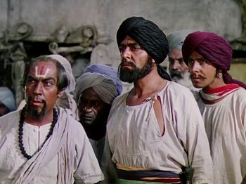 Movie still from “The Jungle Book” (1942), directed by Zoltan Korda – A group of men standing next to each other wearing turbans; Medium shot, Low angle