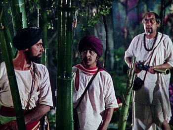 Movie still from “The Jungle Book” (1942), directed by Zoltan Korda – A group of men standing next to each other in the woods; Medium shot, Low angle
