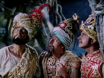 Movie still from “The Jungle Book” (1942), directed by Zoltan Korda – A group of men in costumes singing together; Medium shot, Low angle