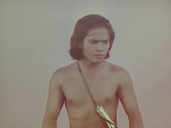 Movie still from “The Jungle Book” (1942), directed by Zoltan Korda – A shirtless man with long hair and a sling; Medium shot, Low angle