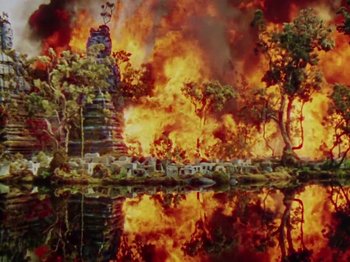 Movie still from “The Jungle Book” (1942), directed by Zoltan Korda – A painting of a burning forest with a castle in the background; Extreme Wide shot, High angle