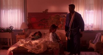 Movie still from “Jungle Fever” (1991), directed by Spike Lee – A man and a woman in a bed room; Wide shot, Low angle