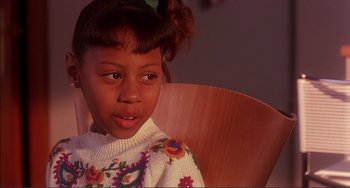 Movie still from “Jungle Fever” (1991), directed by Spike Lee – A little girl sitting in a wooden chair; Close Up shot, High angle