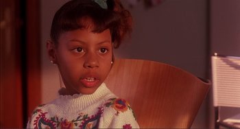 Movie still from “Jungle Fever” (1991), directed by Spike Lee – A little girl sitting in a wooden chair; Close Up shot, High angle