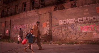 Movie still from “Jungle Fever” (1991), directed by Spike Lee – A man and a little girl walking down a street; Wide shot, Low angle