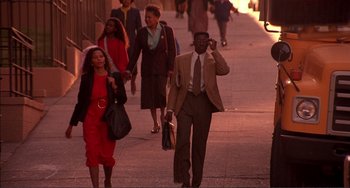 Movie still from “Jungle Fever” (1991), directed by Spike Lee – A group of people walking down a sidewalk; Wide shot, Low angle
