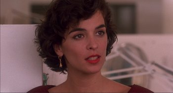 Movie still from “Jungle Fever” (1991), directed by Spike Lee – A person with short hair wearing a dress; Close Up shot, Over the shoulder angle