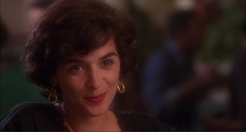 Movie still from “Jungle Fever” (1991), directed by Spike Lee – A person wearing a black shirt; Close Up shot, Over the shoulder angle