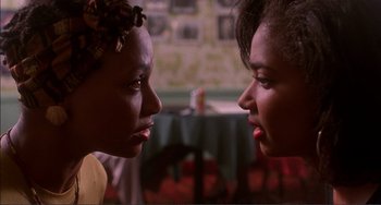 Movie still from “Jungle Fever” (1991), directed by Spike Lee – Two women face each other in a room; Close Up shot, Low angle