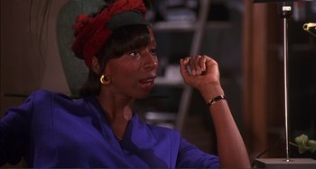 Movie still from “Jungle Fever” (1991), directed by Spike Lee – A black woman with a red head band on; Close Up shot, High angle