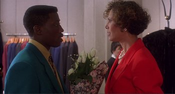 Movie still from “Jungle Fever” (1991), directed by Spike Lee – A man and a woman talking to each other; Medium shot, Over the shoulder angle