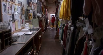 Movie still from “Jungle Fever” (1991), directed by Spike Lee – A woman walking down a hallway in a clothing store; Wide shot, High angle