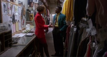 Movie still from “Jungle Fever” (1991), directed by Spike Lee – A man and a woman standing in front of a table; Medium shot, Over the shoulder angle