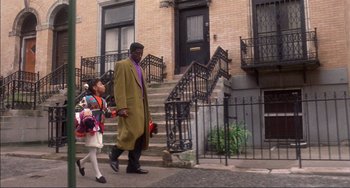 Movie still from “Jungle Fever” (1991), directed by Spike Lee – A man and a little girl walking down a street; Wide shot, Low angle