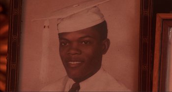 Movie still from “Jungle Fever” (1991), directed by Spike Lee – An old photo of a man wearing a hat; Extreme Close Up shot, Overhead angle