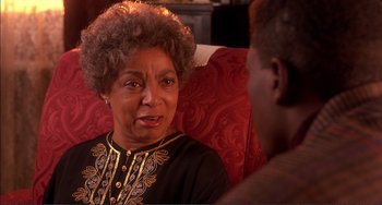 Movie still from “Jungle Fever” (1991), directed by Spike Lee – An older woman talking to a younger man in a chair; Close Up shot, Over the shoulder angle