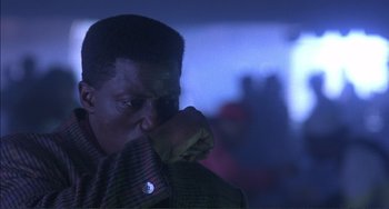 Movie still from “Jungle Fever” (1991), directed by Spike Lee – A person holding his hand to his face; Close Up shot, Low angle