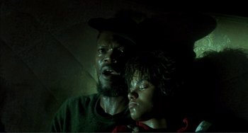 Movie still from “Jungle Fever” (1991), directed by Spike Lee – A man and a woman in a dark room; Close Up shot, Low angle