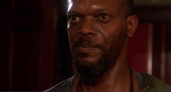 Movie still from “Jungle Fever” (1991), directed by Spike Lee – A person with a beard looking at the camera; Close Up shot, Low angle