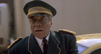 Movie still from “Just My Luck” (2006), directed by Donald Petrie – An older man wearing a uniform and a hat; Close Up shot, Low angle