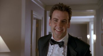 Movie still from “Just My Luck” (2006), directed by Donald Petrie – A man in a tuxedo smiling for the camera; Close Up shot, Low angle