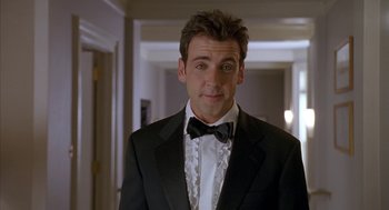 Movie still from “Just My Luck” (2006), directed by Donald Petrie – A person wearing a suit and bow tie; Medium shot, Low angle