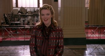 Movie still from “Just My Luck” (2006), directed by Donald Petrie – A woman in a red and black jacket smiling for the camera; Medium shot, Over the shoulder angle
