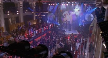 Movie still from “Just My Luck” (2006), directed by Donald Petrie – A crowd of people in a room with lights on; Extreme Wide shot, High angle