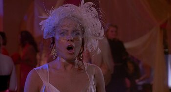 Movie still from “Just My Luck” (2006), directed by Donald Petrie – A woman in a white dress and a white feather hat; Close Up shot, Low angle