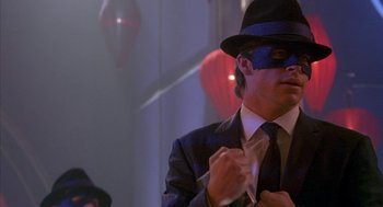 Movie still from “Just My Luck” (2006), directed by Donald Petrie – A man in a suit and a hat with a mask on; Close Up shot, Over the shoulder angle