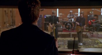 Movie still from “Just My Luck” (2006), directed by Donald Petrie – A man holding a stick in front of an audience; Medium shot, Over the shoulder angle