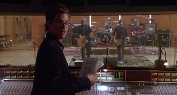 Movie still from “Just My Luck” (2006), directed by Donald Petrie – A man standing in front of a sound mixing board; Close Up shot, Over the shoulder angle
