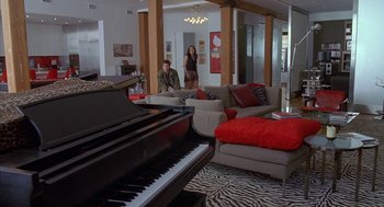 Movie still from “Just My Luck” (2006), directed by Donald Petrie – A man and a woman standing in front of a grand piano; Wide shot, High angle