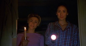 Movie still from “Just My Luck” (2006), directed by Donald Petrie – Two women are holding candles and a flashlight; Medium shot, Low angle