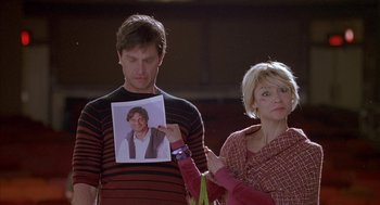 Movie still from “Just My Luck” (2006), directed by Donald Petrie – A man and woman holding up a picture of a man; Close Up shot, Low angle
