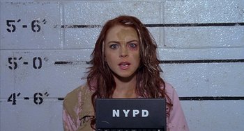 Movie still from “Just My Luck” (2006), directed by Donald Petrie – A woman in a police station holding up a mugshot; Close Up shot, Overhead angle