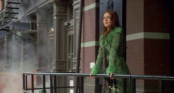 Movie still from “Just My Luck” (2006), directed by Donald Petrie – A woman in a green coat leaning on a railing; Medium shot, Low angle