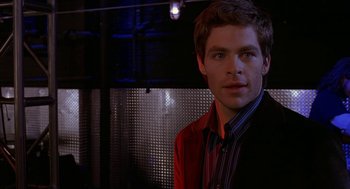 Movie still from “Just My Luck” (2006), directed by Donald Petrie – A man in a red shirt and black jacket; Close Up shot, Over the shoulder angle