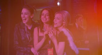 Movie still from “Just My Luck” (2006), directed by Donald Petrie – A group of women sitting next to each other at a party; Medium shot, Over the shoulder angle
