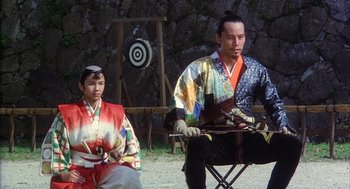 Movie still from “Kagemusha” (1980), directed by Akira Kurosawa – A man and a woman dressed in traditional japanese garb; Medium shot, Low angle