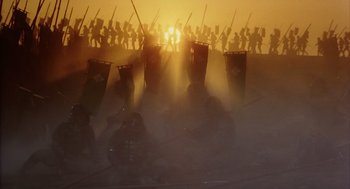 Movie still from “Kagemusha” (1980), directed by Akira Kurosawa – A group of people standing on top of a dirt field; Extreme Wide shot, Low angle