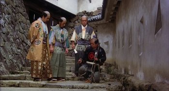 Movie still from “Kagemusha” (1980), directed by Akira Kurosawa – A group of men standing on a set of stairs; Wide shot, High angle