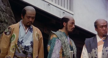 Movie still from “Kagemusha” (1980), directed by Akira Kurosawa – A couple of men standing next to each other on a street; Medium shot, Low angle