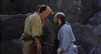 Movie still from “Kagemusha” (1980), directed by Akira Kurosawa – Two men in traditional japanese garb talking to each other; Medium shot, Over the shoulder angle