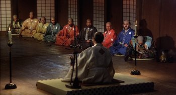 Movie still from “Kagemusha” (1980), directed by Akira Kurosawa – A group of men sitting in a circle on the floor; Wide shot, High angle