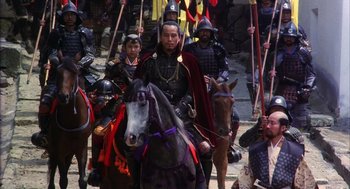 Movie still from “Kagemusha” (1980), directed by Akira Kurosawa – A group of people riding on the backs of horses; Wide shot, High angle