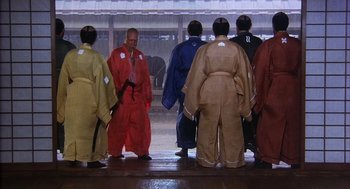 Movie still from “Kagemusha” (1980), directed by Akira Kurosawa – A group of people standing around each other in robes; Wide shot, Low angle