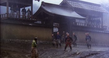 Movie still from “Kagemusha” (1980), directed by Akira Kurosawa – A group of people standing in the rain; Extreme Wide shot, High angle